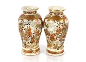 A pair of Japanese Satsuma baluster vases, decorated figures heightened in gilt, character marks