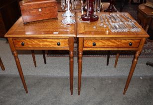 A pair of satin wood cross banded and ebony strung lamp tables, fitted single drawers on rounded