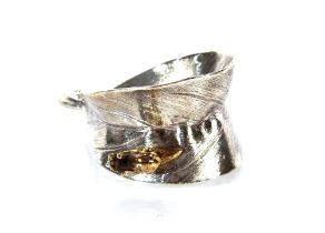 A contemporary design silver and silver gilt napkin ring in the form of a snail on a leaf, by Martin