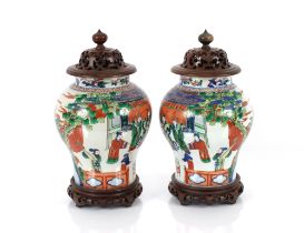 A pair of Chinese baluster vases, decorated figures, foliage and clouds, approx. 38cm high with