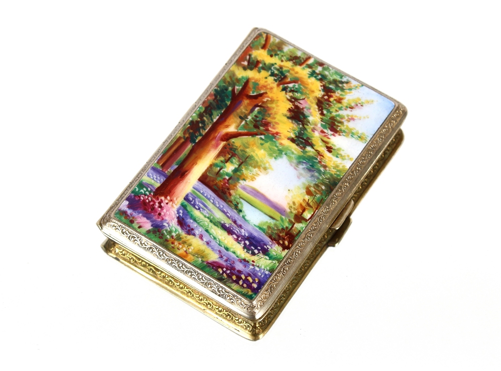 A gold plated and enamel cigarette case, decorated with a bluebell wood, 8.5cm x 6cm
