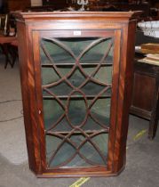 A Georgian mahogany hanging corner cupboard, enclosed by a single glazed tracery door, 77cm wide x