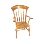 A 19th Century elm seated spindle back kitchen elbow chair