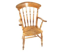 A 19th Century elm seated spindle back kitchen elbow chair