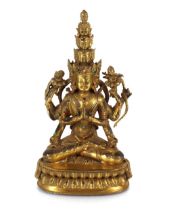 A gilded figure of a Tibetan eight armed deity, 28cm high