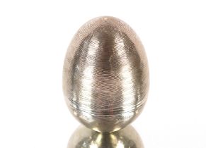 A silver flower egg, from Braybrook & Britten, in the style of Stuart Devlin with ripple engraved