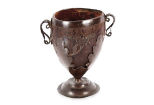 A 18th Century Colonial carved coconut cup, clad with elaborate silver work and decorated with