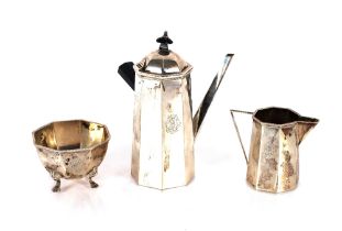 A white metal three piece coffee set, of octagonal form, possibly Chinese, the side pouring coffee