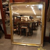 A large modern gilt framed bevel edged wall mirror, 133cm x 103cm