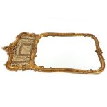 A pair of 19th Century impressive carved gilt wood wall mirrors of shaped rectangular form,