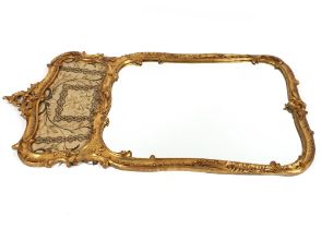 A pair of 19th Century impressive carved gilt wood wall mirrors of shaped rectangular form,
