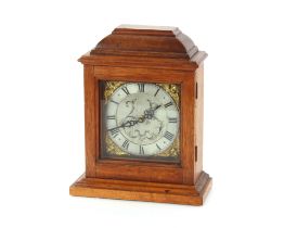 A mahogany cased mantel clock, having ornate brass and steel dial, 27cm high (having battery