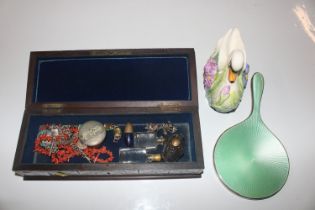 A carved wooden box and contents to include silver