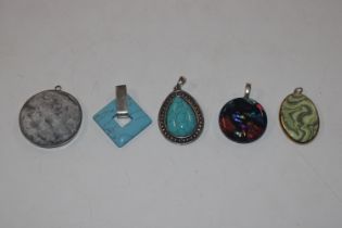 Five white metal and silver mounted pendants inclu