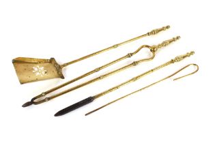 A set of three brass fire implements; and a pair o