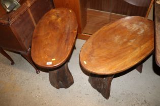 A pair of rustic wooden oval topped side tables