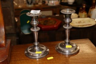 A pair of Mappin & Webb silver plate on copper candlesticks