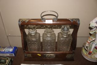 An oak and silver plate mounted three bottle Tanta