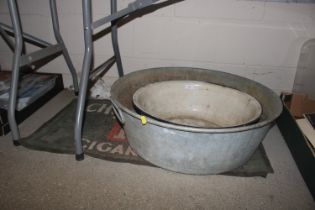 An enamel twin handled bowl, 50cm dia.; a galvanis