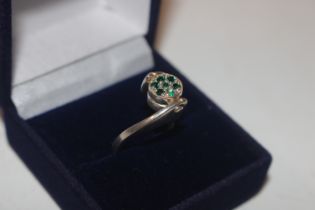 A silver and green stone set reversible ring