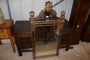 An ornate gilt framed wall mirror