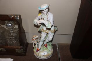 A porcelain figure with attendant dog, initialled