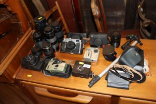 A collection of vintage and modern cameras, lenses