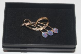 A silver gilt and opal brooch