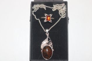 A Sterling silver and amber pendant on chain and s