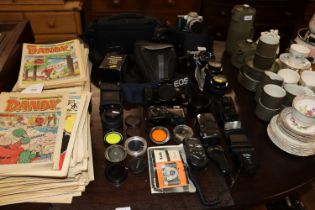 A collection of various cameras, bags and accessor