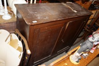 A grained pine two door side cupboard