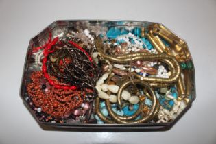 A tin of vintage necklaces including Art Deco styl