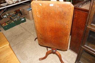 A 19th Century mahogany tilt top table, raised on