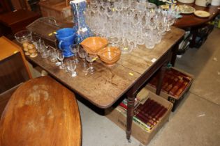 A 19th Century mahogany drop leaf table raised on