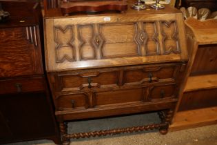 An oak geometric moulded bureau fitted two short o