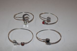 Four white metal and hardstone bangles