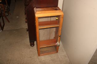 A pine and glazed wall cabinet