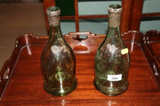 Two antique glass bottles, one bearing label 1904