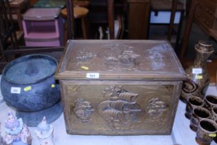 A brass coal box decorated with ships