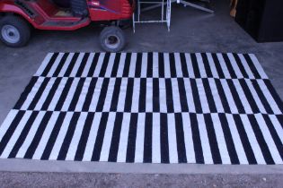 An approx. 7'10" x 5'7" modern stripped patterned