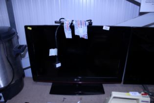 A LG flat screen television and remote control