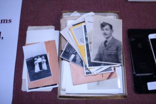 A box of black and white vintage photographs