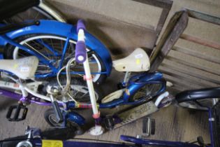 A child's bicycle and a scooter