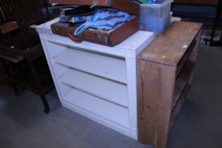 A white painted open fronted bookcase