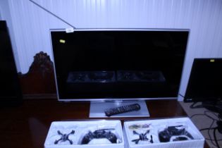 A Panasonic flat screen television and remote cont