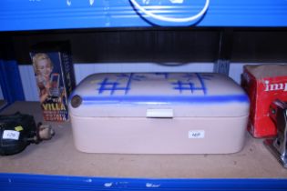 A large ornate enamel bread bin