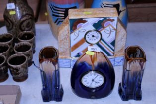 An Art Deco style pottery clock and garnitures tog