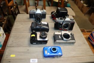 A collection of various cameras to include Canon,