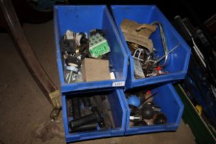 Four plastic bins containing various door handles;