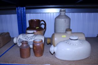 Three stoneware hot water bottles, a Doulton 'Lamb